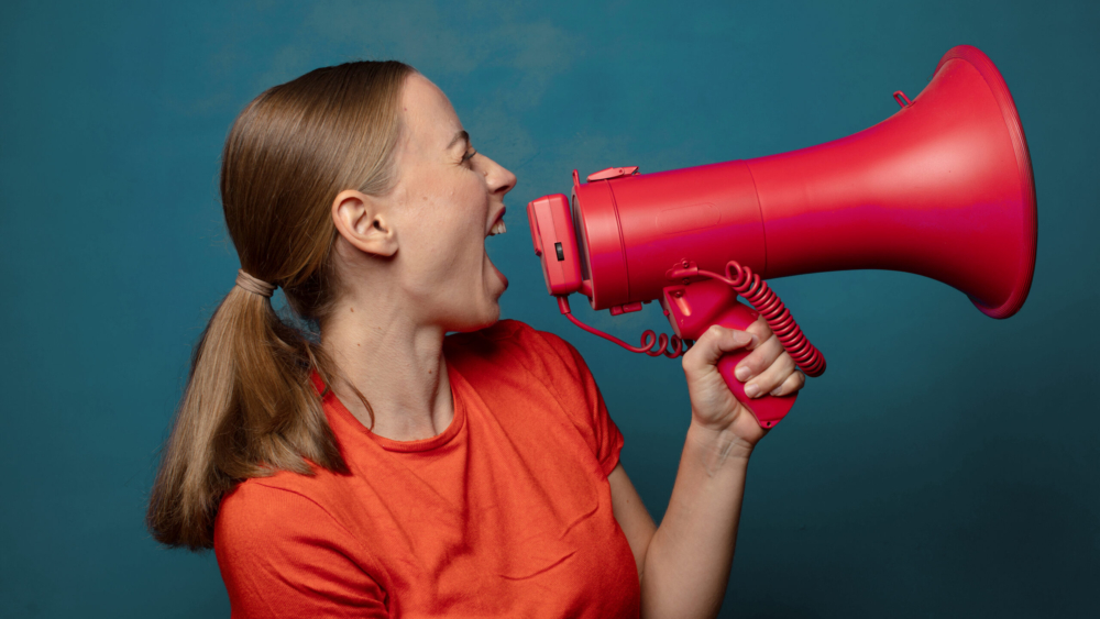 young blonde woman with a megaphone