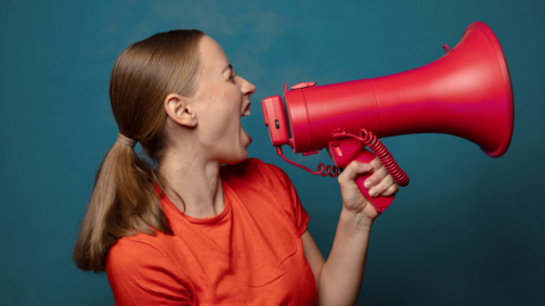 young blonde woman with a megaphone