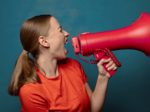 young blonde woman with a megaphone